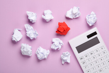 Crumpled paper balls with a calculator on a pastel background. Business concept