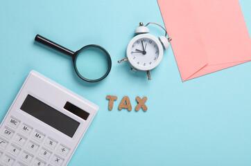 Word tax with magnifier, calculator, envelope and alarm clock on blue background