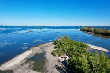Fototapeta premium An aerial photo of coastline near Skyway Bridge, St. Petersburg, Florida, by drone pilot Anita Denunzio.