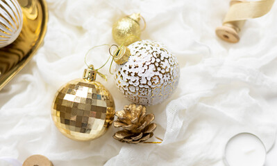 Christmas celebration concept composition with golden and white decoration on the table. Close up