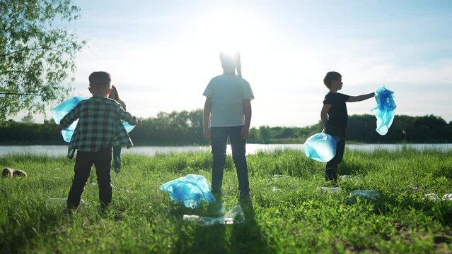 group of volunteers clean up the trash. environmental protection ecology cleaning from garbage plastic concept. group people world volunteers collects plastic bottles garbage in bags silhouette