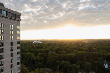 Sun setting over a forested city