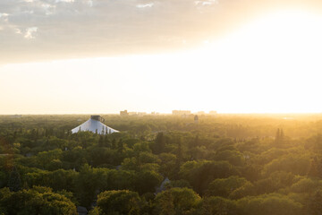 Sun setting over a forested city