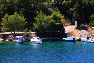 Fototapeta premium Small rustic boat on the promenade. Picturesque scene from Croatia.