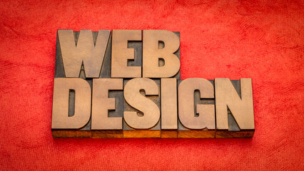web design word abstract in vintage letterpress wood type against textured handmade paper, internet service concept