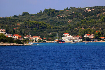 Fototapeta na wymiar Small rustic boat on the promenade. Picturesque scene from Croatia.