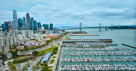 Aerial South Beach Harbor with Oakland Bay Bridge leading to downtown skyscrapers