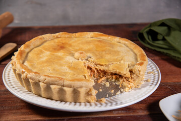 slice of chicken pie on rustic wooden background