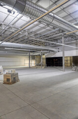 industrial air conditioning hvac in the ceiling of a warehouse in construction, conditioning system already in place