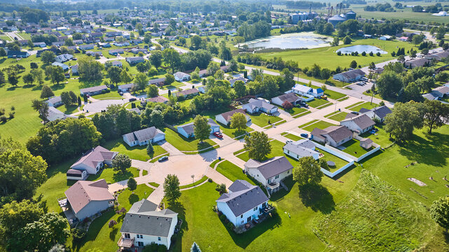 Aerial generic neighborhood with houses around different culdesacs and distant ponds