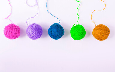 Colored threads for knitting on the white background. Top view. Copy space.