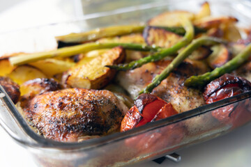 Home cooked food. Fried chicken with potatoes, tomatoes and asparagus.