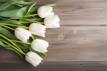 White tulips on wood table.