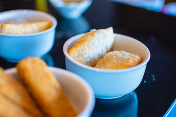 Chicken pastries, cheese pastries, meat pastries in white porcelain bowls