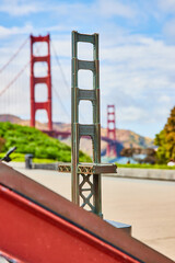 Close up of Golden Gate Bridge replica with bridge in background on bright summer day