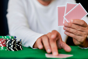 Man playing cards in casino, closeup