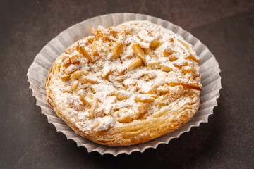Traditional Portuguese almond tart with caramel and powdered sugar. Close up