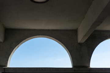 lunette openings in a wall with a view out to the sky beyond