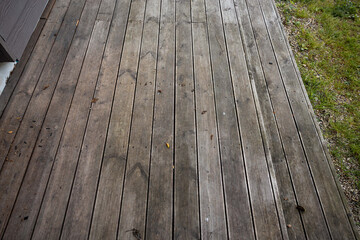 Weathered wooden deck, terrace with algae and moss, spring cleaning in garden and yard