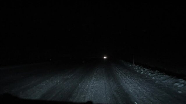 Driving on a road on a dark winter night