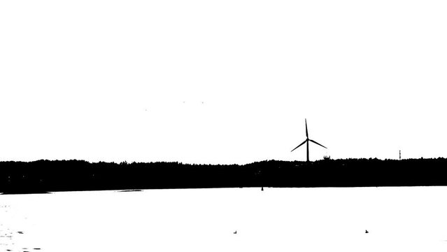 Black and white high contrast video of wind power pland by the sea