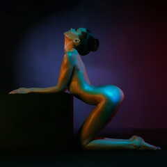 A woman dances in a nightclub. Beautiful figure of a nude model. Sexy lady. - 665146151
