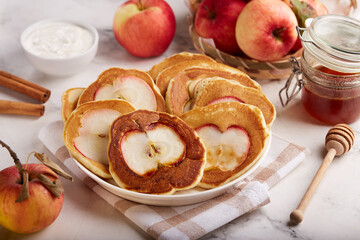 Naklejka na ściany i meble Pancakes with apples, served with sour cream and honey. Healthy breakfast for the family. 