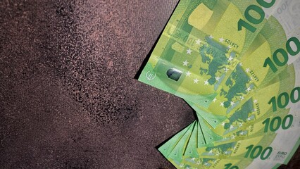 Euro banknotes on a dark background