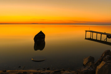 sunrise with boats on the lake