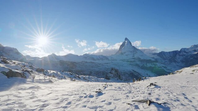 Panoramic nature landscape of Matterhorn Hiking trails covering with winter snow on a sunny day in Zermatt, Switzerland. World most famous mountains and travel ski resort in Swiss alps. Static view.