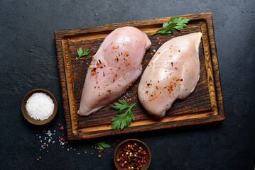Raw organic chiken breasts with ingredients for making. Top view with copy space.