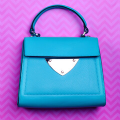 Stylish turquoise leather women's flap bag with top handle and silver accent and hardware on a fun...