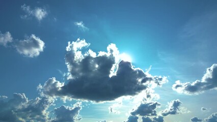 Blue sky and white clouds floated in the sky on a clear day with warm sunshine combined with cool breeze blowing against the body resulting in a miraculous refreshing like paradise.