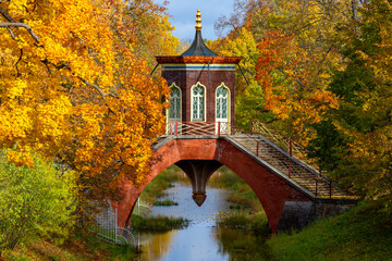 Cross bridge in autumn foliage in Alexander park, Tsarskoe Selo (Pushkin), Saint Petersburg, Russia