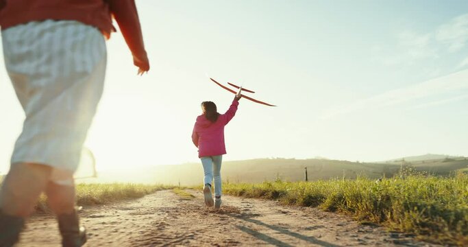 Girl, mom and outdoor for plane, toys and back with games, running and summer sunshine in countryside. Airplane, mother and daughter on path for vacation, freedom and playful bonding in nature