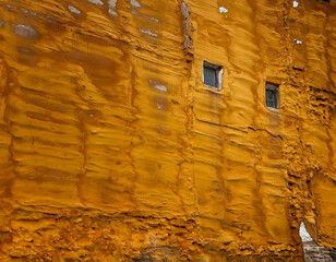 Golden foam protection in party wall with two windows, polyurethane foam coating, Waterproofing...