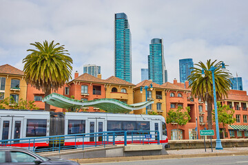 City transportation stopped at Embarcadero bus stop with wavy overhang and skyscrapers