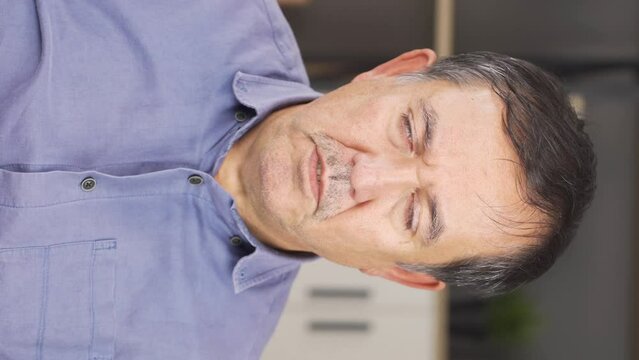 Vertical video of Angry and grumpy old man.