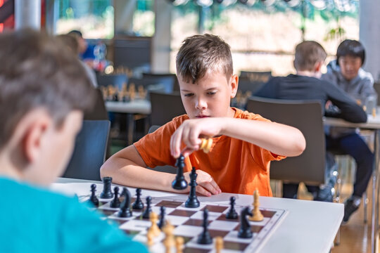 A school kid taking part in a chess tournament 