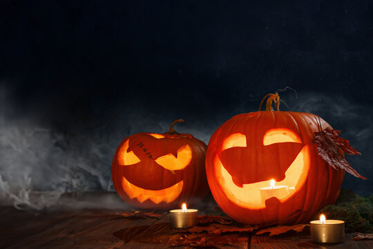Halloween pumpkins festive background. Moonlight and candlelight. Jack-o-lantern halloween mystic background with mist, spiders, bat and fog, bats