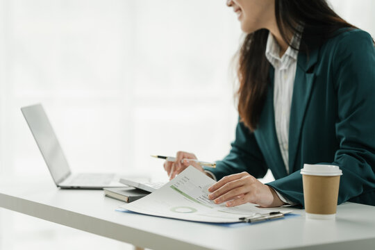 Financial institution worker female asian people, professionals engrossed in tasks. Business people diligently crunching numbers, advising clients, and securing deals from their desks.