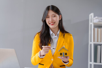 Yellow suit female asian people real estate agents and loan providers at work. Business...