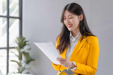 Yellow suit female asian people real estate agents and loan providers at work. Business...