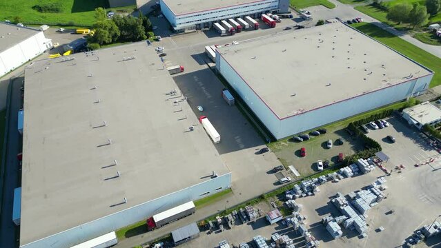 Warehouse storages or industrial factory or logistics center from above. Aerial view of industrial buildings and equipment machines. Aerial view