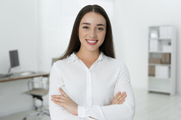 Portrait of beautiful young woman in office