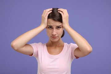 Portrait of resentful woman on violet background