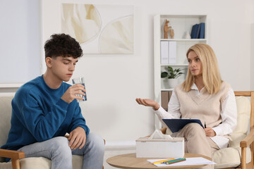 Obraz premium Psychologist working with teenage boy in office. Teenager problems