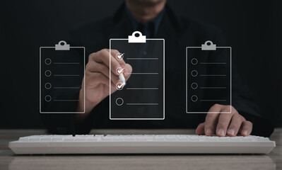 Performance checklist concept : businessman using stylus pen with laptop for questionnaire,...