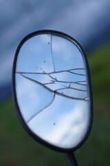 Broken motorcycle side mirror Beautiful rice field background on the mountain On the background of green mountains beautiful blue sky