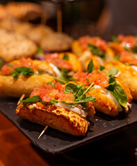 Arugula, tomato, mozzarella pintxos on a tray